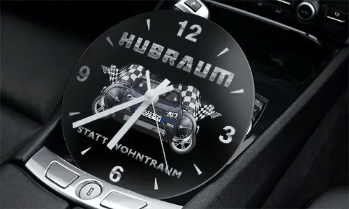 Racing-themed clock in car console with two cars, checkered flags, and HUBRAUM STATT WOHNTRAUM text