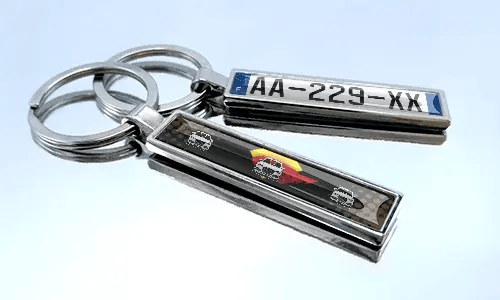 Metal comic keychain with car design and license plate detail