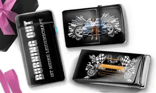 Drei schwarze Geldbörsen mit Auto-Designs. Eine trägt die Aufschrift „Burning Out ist meine Leidenschaft“, eine andere zeigt ein Auto mit Kolben und einer Person, und die dritte zeigt ein Auto mit karierten Flaggen und Kolben. In der Ecke liegt eine violette Schleife.