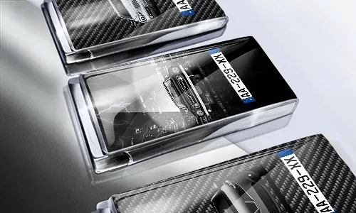 Three car-themed boxes with glossy finish: silver with car, black with cityscape and black car, red with car front