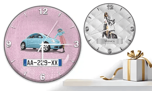 Zwei Wanduhren mit weiblichen Figuren und Fahrzeugen: links mit schwarzem Auto vor lila Wellen, rechts mit rotem und schwarzem Auto, Rennflaggen und blauem Hintergrund
