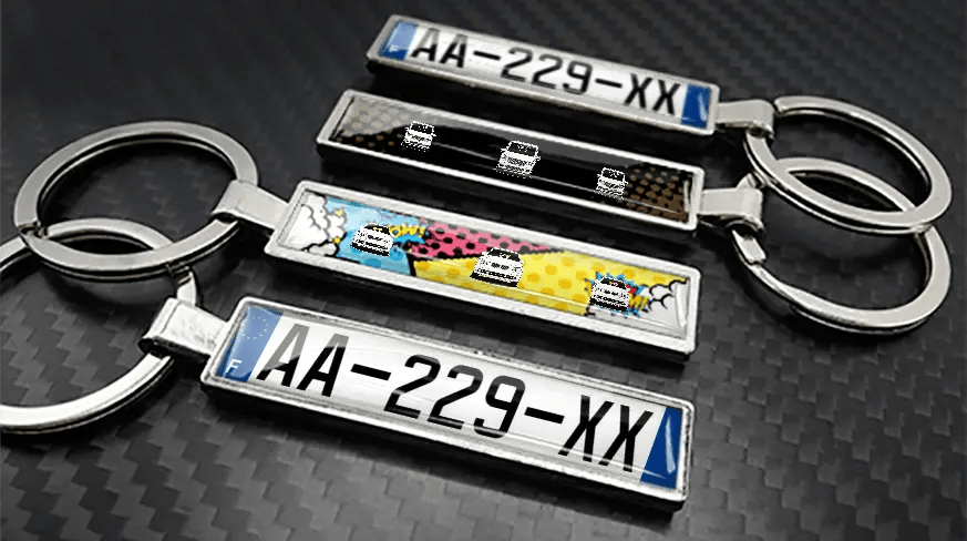 Comic style metal keychains with car illustrations and custom license plate design
