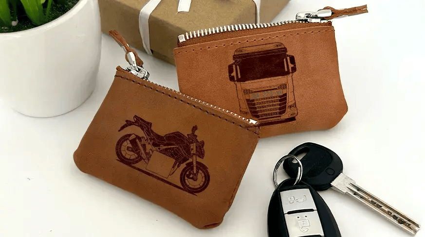 Two brown leather key pouches with zippers: one with motorcycle and plate 